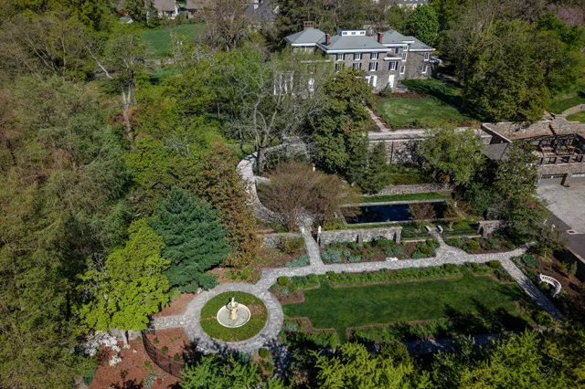 Aerial view of the historic Gibraltar Estate in Wilmington, Delaware, featuring formal parterre gardens, circular fountain, and stone manor house, maintained and restored by Eastern Horticultural Services