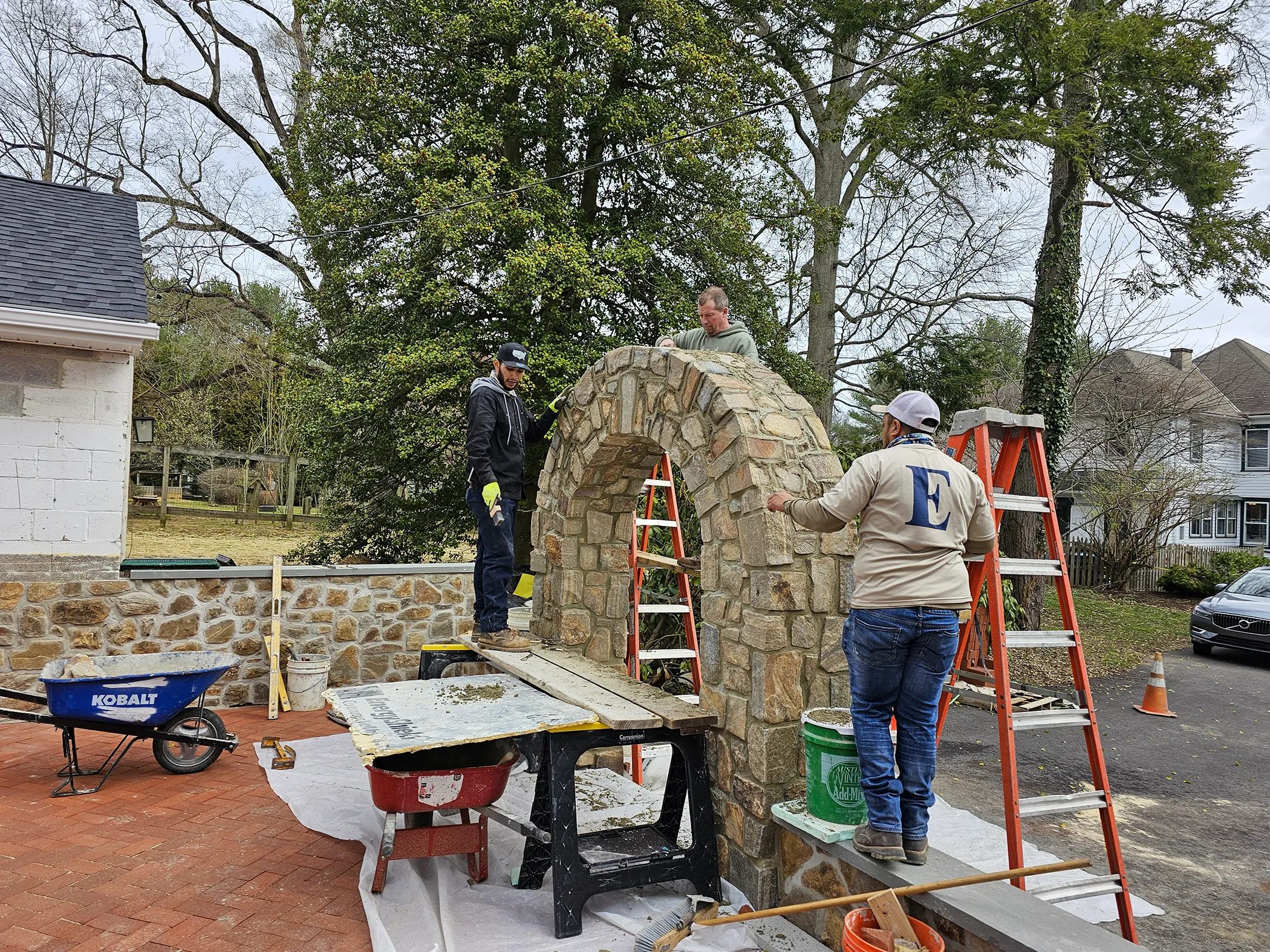 EHS crew on ladders setting the fieldstone arch at Fairville Friends School, Chadds Ford, PA