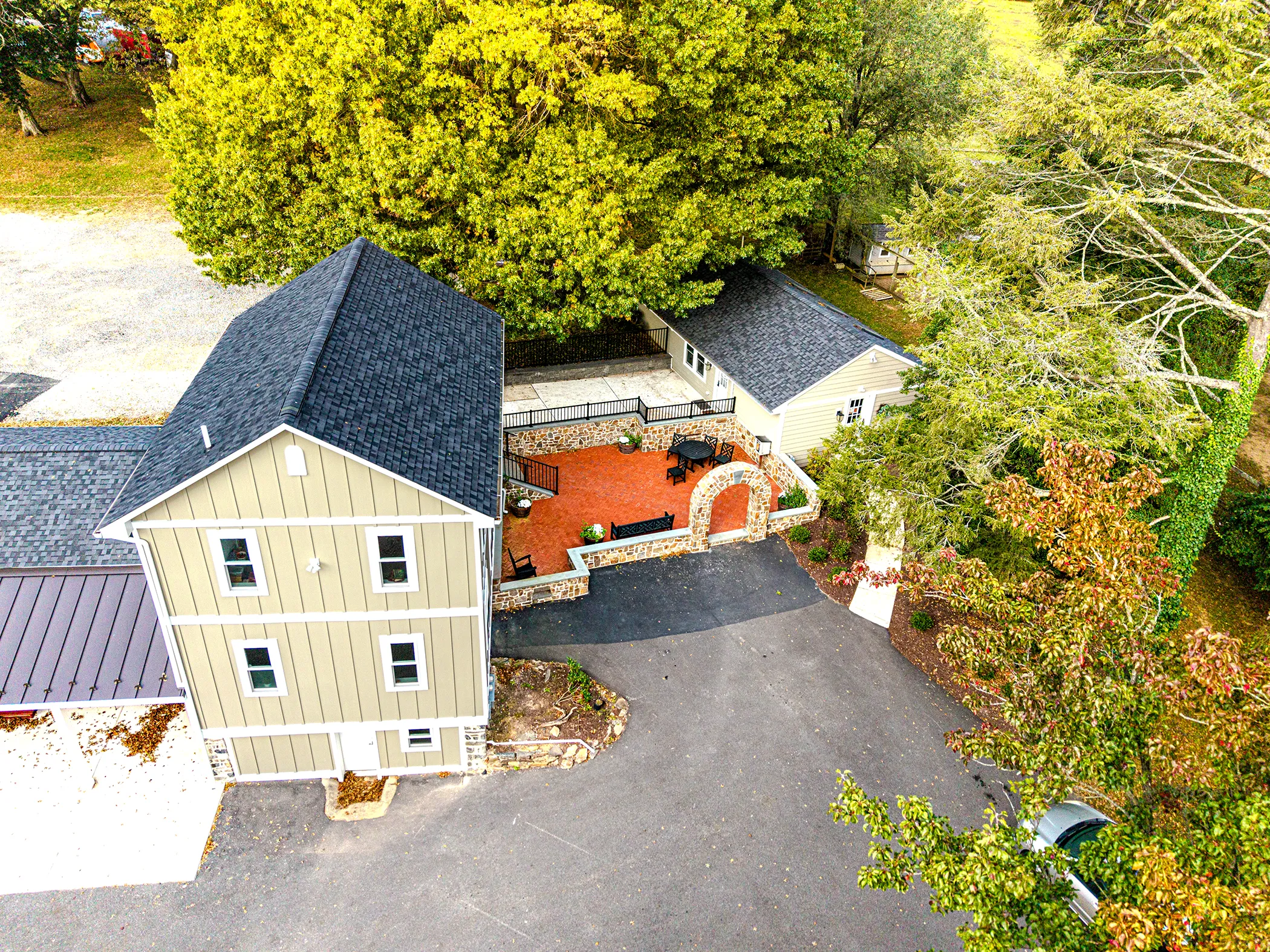 Wide aerial view of Fairville Friends School campus with completed fieldstone courtyard and arch, Chadds Ford, PA